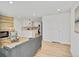 Bright and open-concept living room flowing into a modern kitchen at 7826 Joan Dr, Denver, CO 80221
