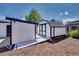 White shed with black trim located in the backyard at 7826 Joan Dr, Denver, CO 80221