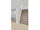 Carpeted staircase with a white banister leading to the upper level at 7826 Joan Dr, Denver, CO 80221