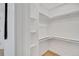 Walk-in closet with shelving, ample storage space, and wood flooring at 7826 Joan Dr, Denver, CO 80221
