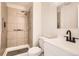 Updated bathroom with shower, grab bars, modern vanity, and fixtures at 15510 E Bates Ave, Aurora, CO 80013