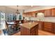 Kitchen with wooden cabinetry, granite countertops, and stainless steel appliances at 8512 S Lewis Way, Littleton, CO 80127