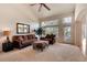 Bright living room featuring large windows and comfortable furniture at 8512 S Lewis Way, Littleton, CO 80127