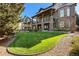 Spacious backyard features a lush lawn, rock garden, and balcony off the rear of the home at 24273 E Fremont Dr, Aurora, CO 80016