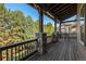 Spacious upper-level balcony with wood flooring, stone pillars and outdoor dining at 24273 E Fremont Dr, Aurora, CO 80016