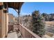 Balcony overlooking a quiet neighborhood street with mature trees and blue skies at 24273 E Fremont Dr, Aurora, CO 80016