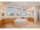 Elegant bathroom with a tiled tub and dual vanity areas and lots of natural light at 24273 E Fremont Dr, Aurora, CO 80016