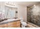 Bathroom featuring a walk-in glass shower with tile surround and a single sink vanity at 24273 E Fremont Dr, Aurora, CO 80016