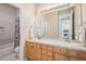 Bathroom featuring double sinks, wood cabinets, tile flooring and a shower with a decorative curtain at 24273 E Fremont Dr, Aurora, CO 80016