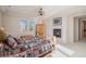 Cozy main bedroom features a ceiling fan, fireplace, natural light and rustic decor at 24273 E Fremont Dr, Aurora, CO 80016