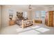 Bright bedroom with three windows, ceiling fan, and log-frame bed and bedside tables at 24273 E Fremont Dr, Aurora, CO 80016