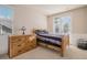 Comfortable bedroom with a wooden bed frame, dresser, and carpet flooring with natural light at 24273 E Fremont Dr, Aurora, CO 80016