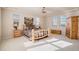 Spacious bedroom featuring a rustic wooden bed frame, cabinetry, ceiling fan, and plenty of natural light at 24273 E Fremont Dr, Aurora, CO 80016