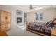 Charming bedroom with a log-frame bed, bedside tables, fireplace, and ceiling fan at 24273 E Fremont Dr, Aurora, CO 80016