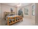 Cozy bedroom with a rustic wooden bed frame and bright natural light from large windows at 24273 E Fremont Dr, Aurora, CO 80016