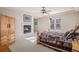 Comfortable bedroom features a fireplace, natural light, rustic decor, and a ceiling fan at 24273 E Fremont Dr, Aurora, CO 80016