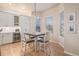 Sunlit dining area with a modern pendant light fixture and seamless access to the kitchen at 24273 E Fremont Dr, Aurora, CO 80016