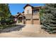 Beautiful home featuring a stone and siding exterior, two-car garage, and an inviting covered front porch at 24273 E Fremont Dr, Aurora, CO 80016