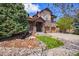 Beautiful two-story home with a stone facade, complemented by a lush green lawn and mature landscaping at 24273 E Fremont Dr, Aurora, CO 80016
