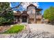 Charming two-story home featuring stone accents, a well-manicured lawn, and an attached two-car garage at 24273 E Fremont Dr, Aurora, CO 80016