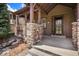 Inviting front porch with stone columns and wood accents, leading to a welcoming front door at 24273 E Fremont Dr, Aurora, CO 80016