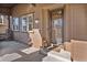 Inviting covered porch featuring a decorative front door and wood siding, creating a warm welcome at 24273 E Fremont Dr, Aurora, CO 80016