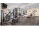 Well-equipped home gym with modern exercise machines, weights, and ample space for workouts at 24273 E Fremont Dr, Aurora, CO 80016