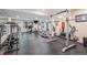 Spacious home gym with various equipment and a mirrored wall, ideal for fitness enthusiasts at 24273 E Fremont Dr, Aurora, CO 80016