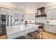 Elegant kitchen with island, stainless appliances, and custom range hood at 24273 E Fremont Dr, Aurora, CO 80016