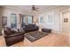 Bright living room with hardwood floors, a comfortable leather sofa, and natural light from large windows at 24273 E Fremont Dr, Aurora, CO 80016