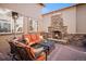 Covered patio features an outdoor fireplace, comfortable seating, and views at 24273 E Fremont Dr, Aurora, CO 80016