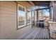 Relaxing outdoor patio area with a grill, wood flooring, and glass doors at 24273 E Fremont Dr, Aurora, CO 80016