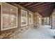 Covered patio featuring brick accents, a concrete floor, and multiple windows for natural light at 24273 E Fremont Dr, Aurora, CO 80016