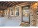 Inviting front porch with brick detail, multiple windows and glass front door with a hello mat at 24273 E Fremont Dr, Aurora, CO 80016