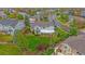 Aerial view of the home with a large lawn, beautiful landscaping, and covered patio in a residential neighborhood at 6393 S Richfield St, Aurora, CO 80016