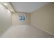 Finished basement with a window and neutral walls complementing the light hardwood floors at 6393 S Richfield St, Aurora, CO 80016