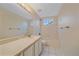 Bathroom featuring a single sink vanity, toilet, and a shower/tub with tile surround at 6393 S Richfield St, Aurora, CO 80016