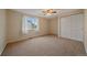 Bedroom with a large window, a ceiling fan, carpeted flooring, and closet at 6393 S Richfield St, Aurora, CO 80016