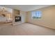 Bonus room features a fireplace, window with views, and neutral walls and carpet at 6393 S Richfield St, Aurora, CO 80016