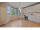 Bright breakfast nook with large windows, built-in cabinets, and a modern chandelier at 6393 S Richfield St, Aurora, CO 80016