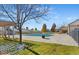 Community pool covered for the winter with lawn and patio area with views of the green space at 6393 S Richfield St, Aurora, CO 80016