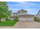 Beautiful two-story home featuring manicured lawn, stone accents, and a three-car garage at 6393 S Richfield St, Aurora, CO 80016