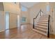 Bright foyer featuring hardwood floors and a staircase with a black handrail at 6393 S Richfield St, Aurora, CO 80016