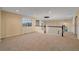 Bright upstairs hallway with large windows and natural light, neutral walls, and carpeted flooring at 6393 S Richfield St, Aurora, CO 80016