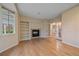 Sun-filled living room with hardwood floors, a fireplace, built-in shelving, and glass French doors at 6393 S Richfield St, Aurora, CO 80016