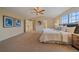 Large main bedroom features a vaulted ceiling, carpeted flooring, and doorway to the ensuite bathroom at 6393 S Richfield St, Aurora, CO 80016