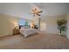 Spacious main bedroom with vaulted ceiling, ceiling fan, fireplace, and large windows at 6393 S Richfield St, Aurora, CO 80016