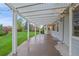 Covered patio with string lights and spacious area for outdoor seating and entertaining overlooking the lawn at 6393 S Richfield St, Aurora, CO 80016