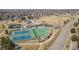 Aerial view of community tennis and basketball courts and surrounding neighborhood on a bright sunny day at 6393 S Richfield St, Aurora, CO 80016