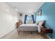 This bedroom features a queen-size bed, a wooden dresser, and a large window at 8738 Chase Dr # 133, Arvada, CO 80003
